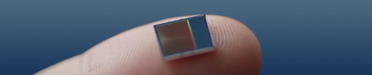 IMX500 chip balanced on a fingertip